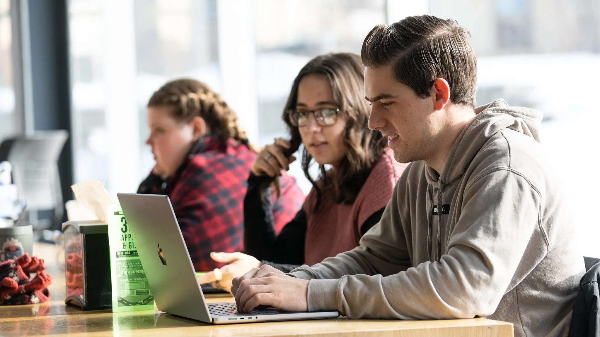 Two students working together on laptop