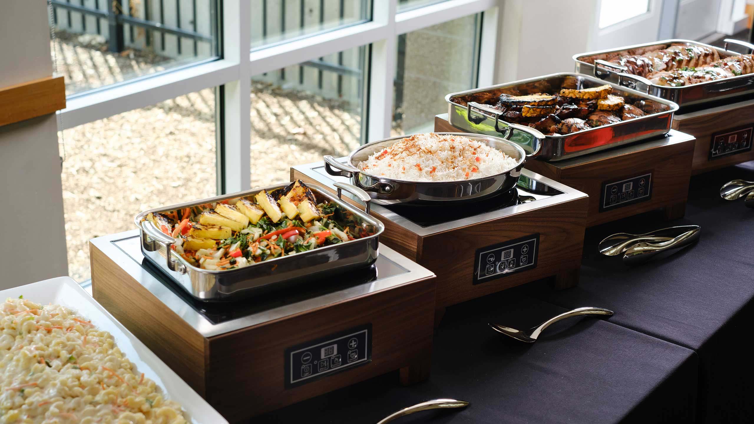 A catered buffet table with various dishes